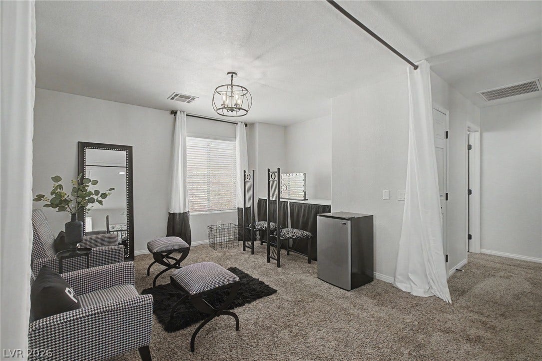 6025 Glenborough Street, North Las Vegas, NV 89115 Plush wall-to-wall carpeting and clean neutral walls anchor this versatile secondary living space.