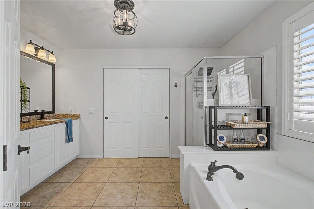 6025 Glenborough Street, North Las Vegas, NV 89115 A classic bathtub and tile flooring anchor this well-appointed bathroom space.
