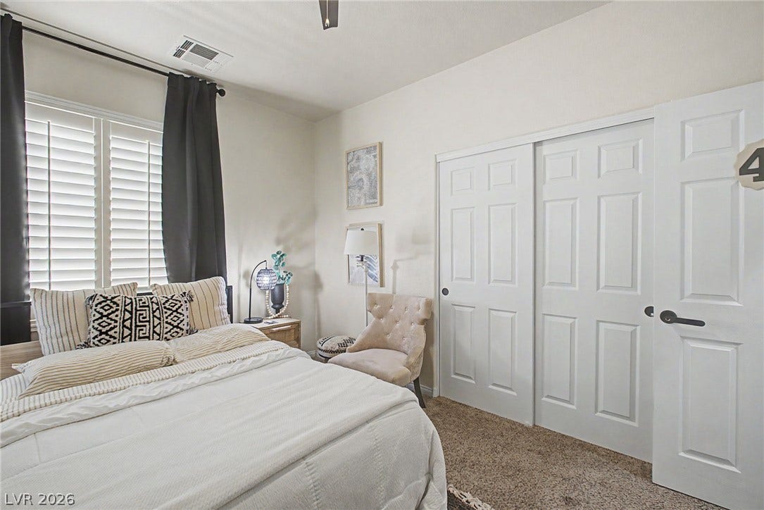 6025 Glenborough Street, North Las Vegas, NV 89115 Plentiful natural light streams across soft carpeting and clean architectural lines.
