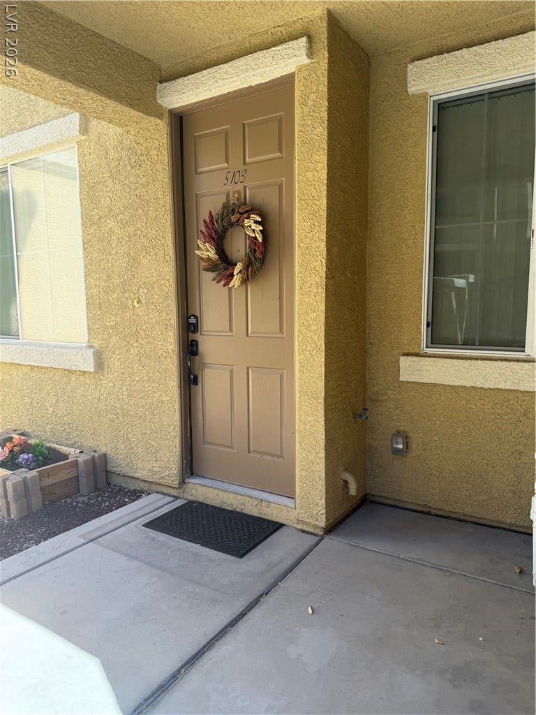 A private entrance path leads to the front door under a sheltered alcove.