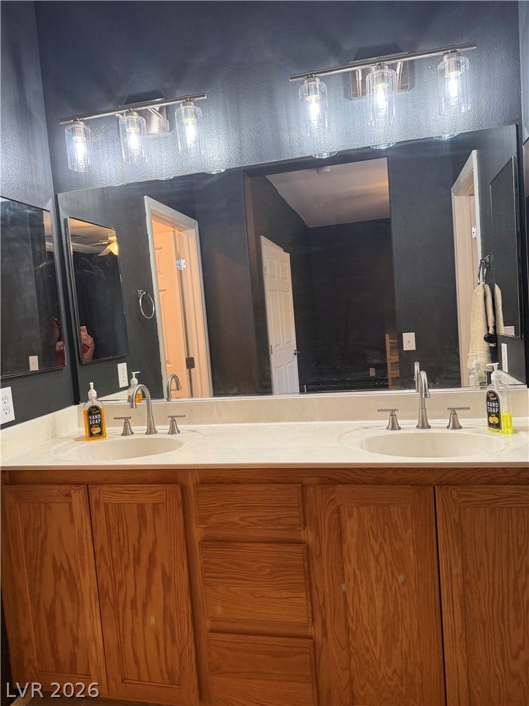 A spacious double vanity anchors this master bathroom, complete with rich oak cabinetry.