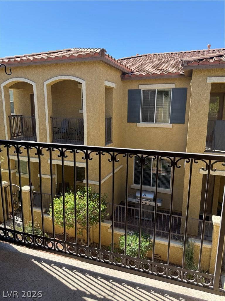 Mediterranean-inspired architecture highlights this multi-level exterior courtyard view showcasing classic tile roofing.
