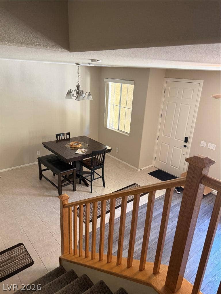 An open entryway leads directly into a versatile dining area with tiled flooring.