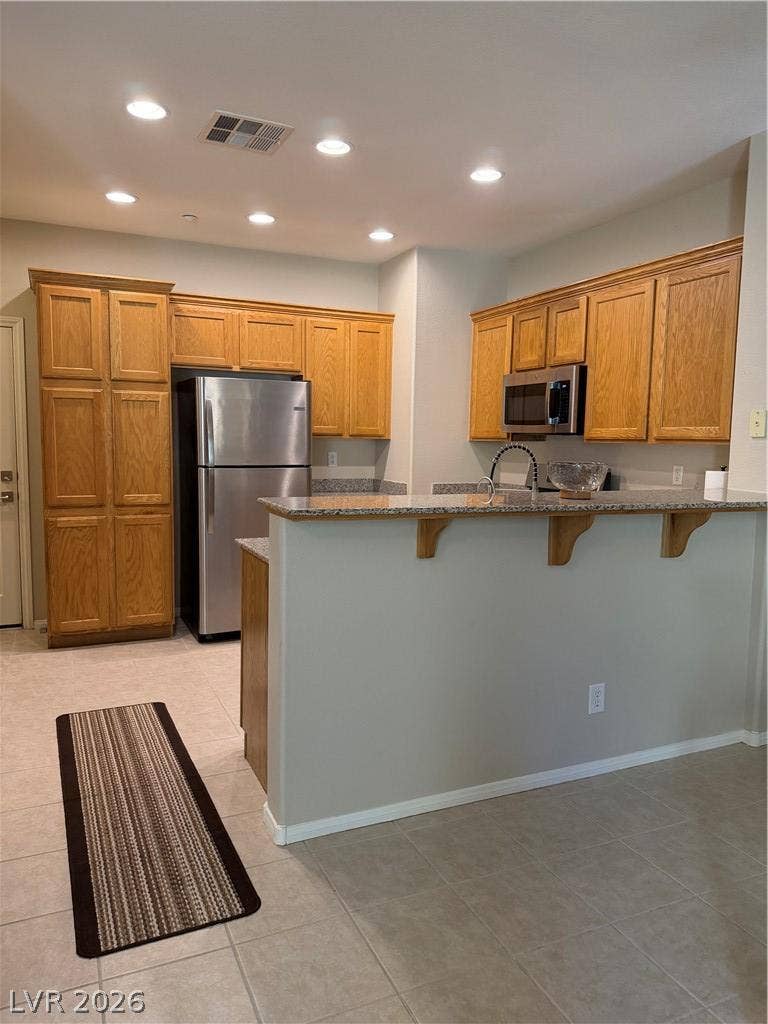 Gleaming stone countertops and classic wood cabinetry define this functional culinary space.