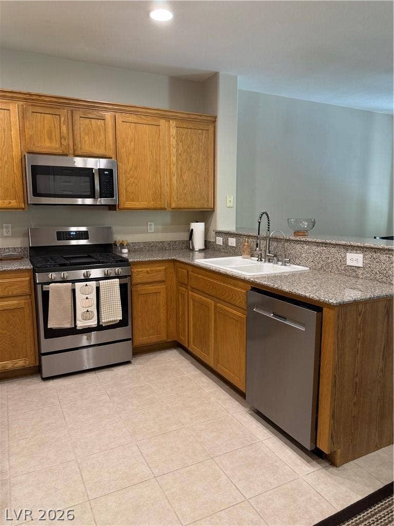 Warm wood cabinetry pairs with durable granite countertops in this functional workspace.