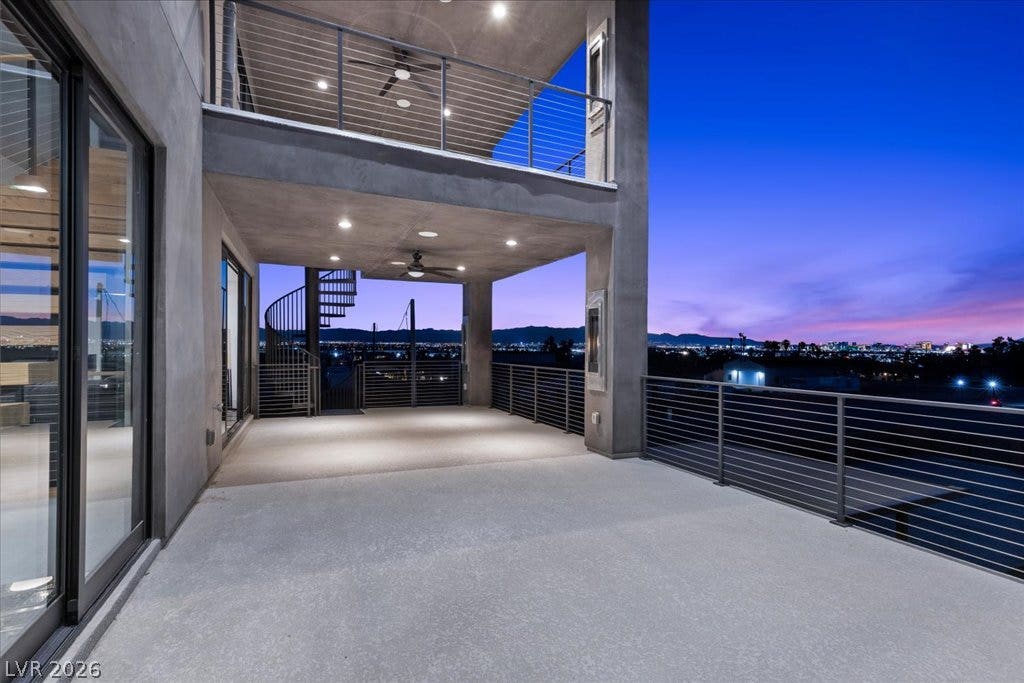 2839 Edgemont Drive, Henderson, NV 89074 City lights twinkle beyond this modern deck, offering serene sunset views and ample outdoor space.