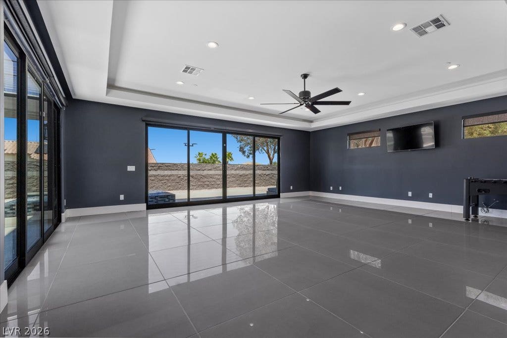 2839 Edgemont Drive, Henderson, NV 89074 Floor-to-ceiling glass doors open to outdoor views, complementing the sleek tiled flooring.