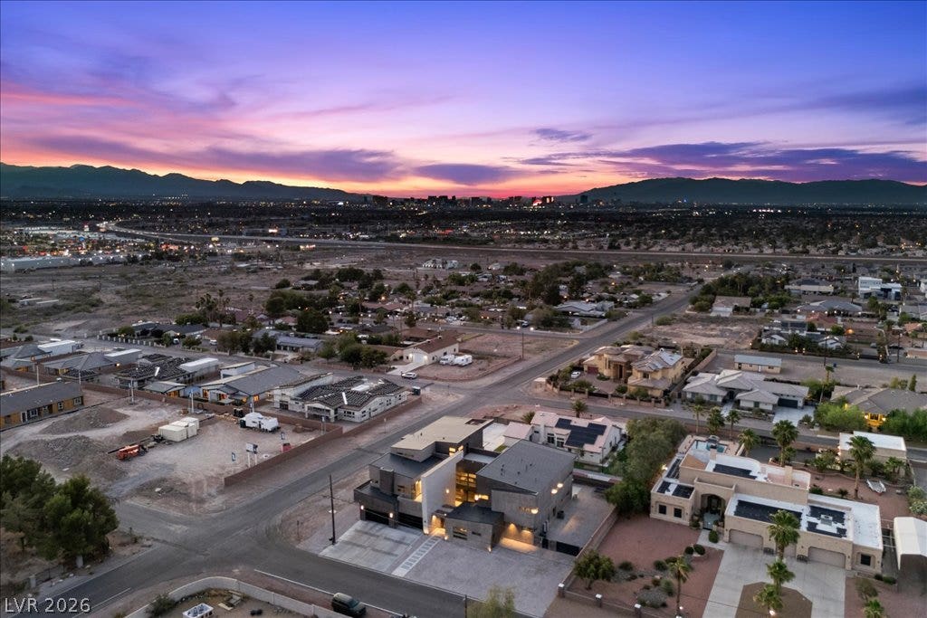 2839 Edgemont Drive, Henderson, NV 89074 Witness the modern architecture of a grand residence against a dramatic, colorful evening sky.