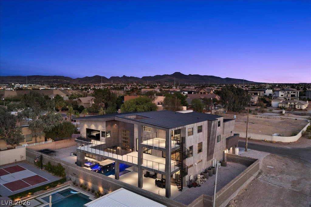 2839 Edgemont Drive, Henderson, NV 89074 Dramatic modern architecture with illuminated pool and mountain views, perfect for evening entertaining.