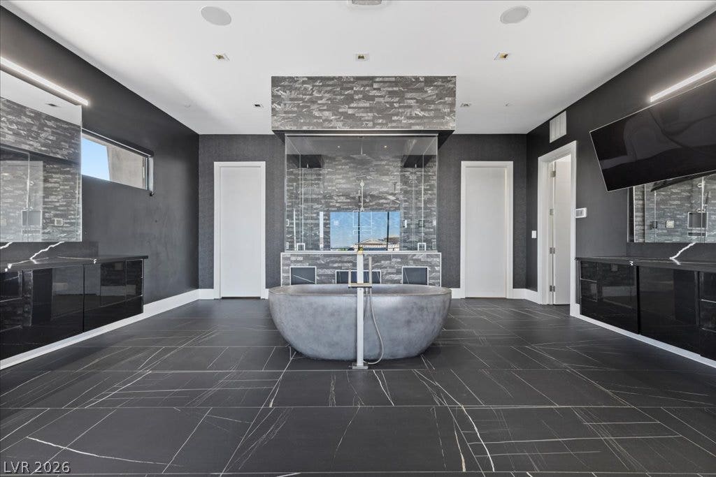 2839 Edgemont Drive, Henderson, NV 89074 A lavish bath with a freestanding soaking tub and dual vanities elevates the daily routine.