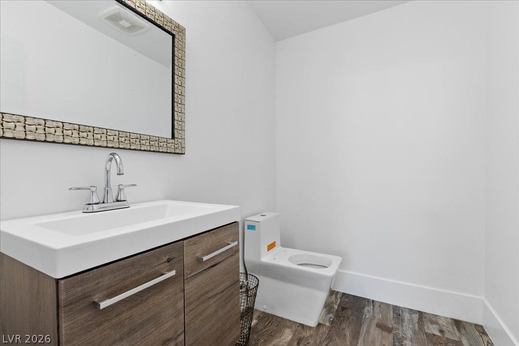 2839 Edgemont Drive, Henderson, NV 89074 A well-lit powder room boasts a contemporary vanity and stylish wood-look flooring.
