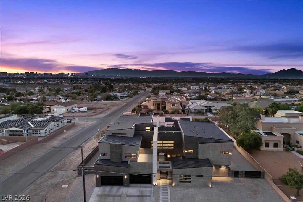 2839 Edgemont Drive, Henderson, NV 89074 Dramatic modern architecture with a striking facade, perfectly framed by the vibrant twilight sky and distant city lights.
