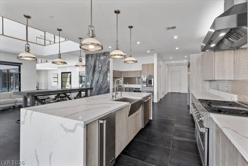 2839 Edgemont Drive, Henderson, NV 89074 A spacious, open-concept kitchen features a grand island, abundant cabinetry, and a full suite of modern appliances.