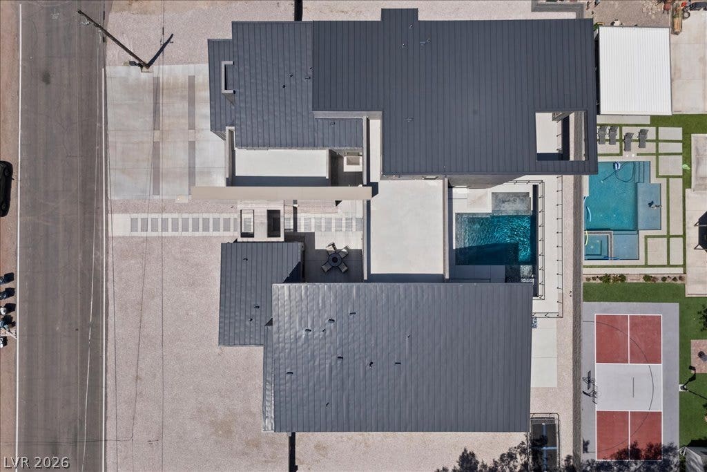 2839 Edgemont Drive, Henderson, NV 89074 An aerial perspective reveals a modern residence featuring a private pool and an outdoor basketball court.