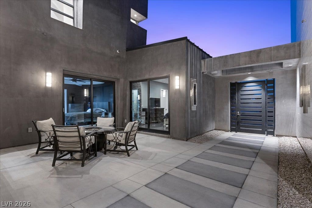 2839 Edgemont Drive, Henderson, NV 89074 An inviting private courtyard features sleek concrete pavers and an imposing modern entry.