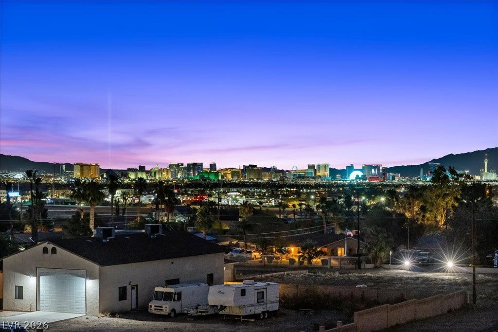2839 Edgemont Drive, Henderson, NV 89074 City lights shimmer against the twilight sky, offering captivating views from this property.