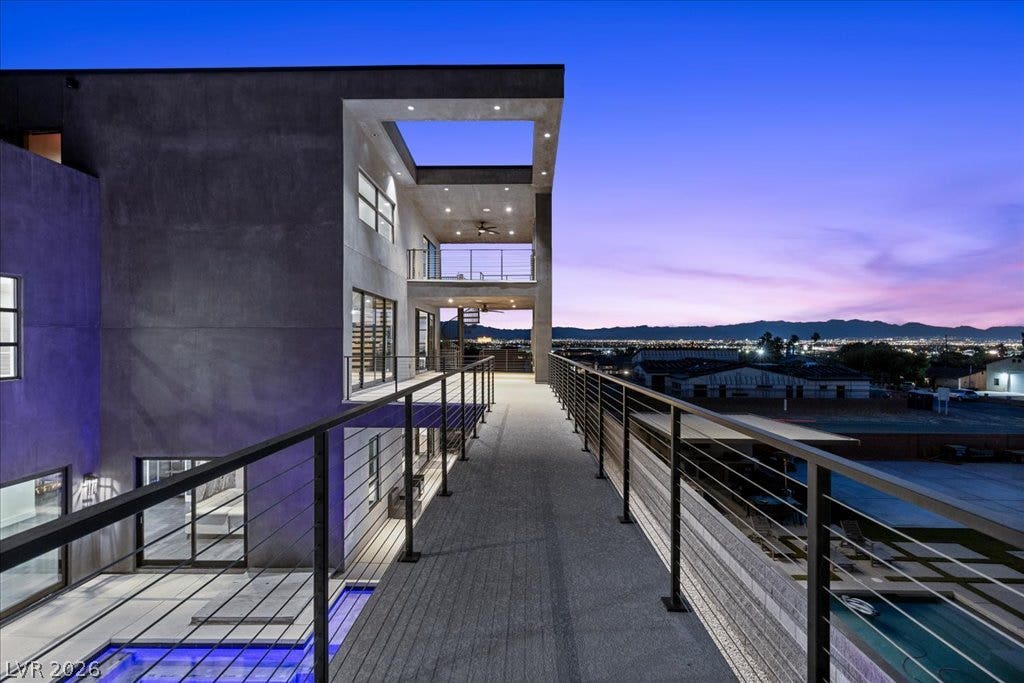 2839 Edgemont Drive, Henderson, NV 89074 An architectural marvel, this multilevel residence showcases expansive balconies overlooking city lights and distant mountains.