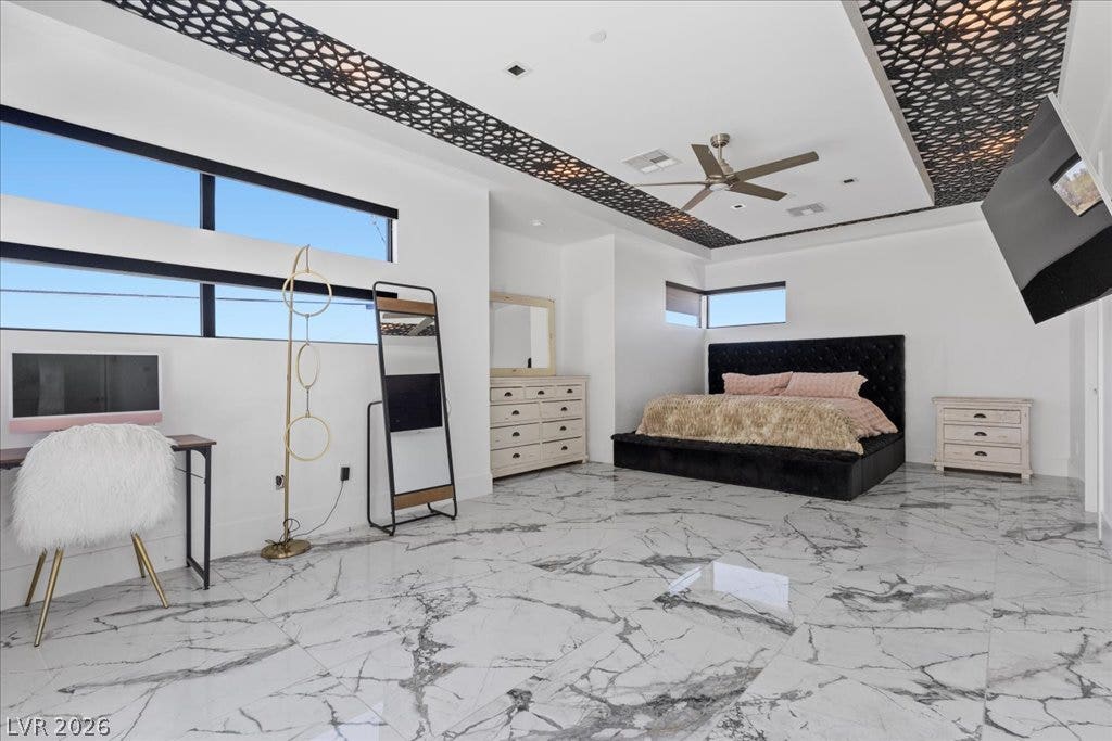 2839 Edgemont Drive, Henderson, NV 89074 Ornate ceiling details and sleek tile flooring define this spacious bedroom's unique character.
