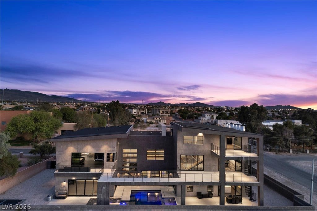 2839 Edgemont Drive, Henderson, NV 89074 Modern desert oasis featuring multiple levels of balconies, a private pool, and panoramic mountain views.