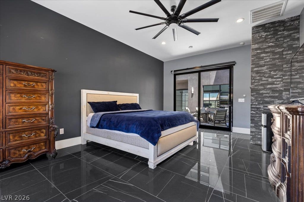 2839 Edgemont Drive, Henderson, NV 89074 Step into this refined bedroom featuring a modern ceiling fan, sleek tile flooring, and access to a private outdoor space.