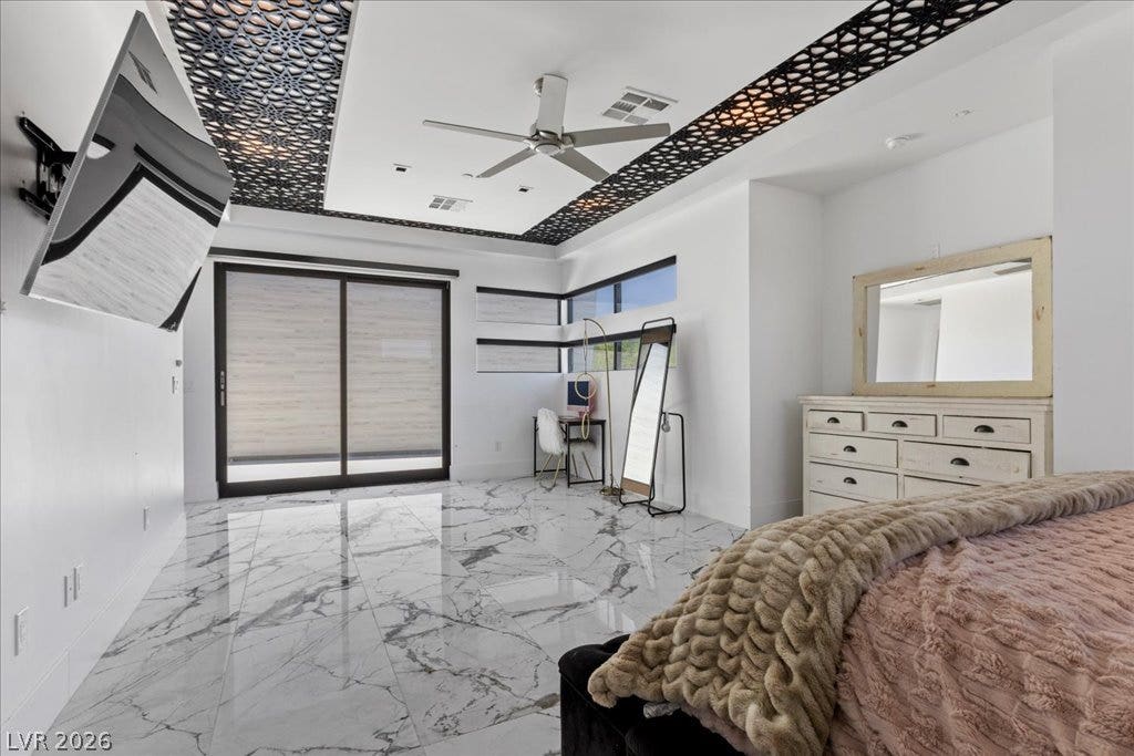 2839 Edgemont Drive, Henderson, NV 89074 Marble-patterned flooring and decorative ceiling details define this primary bedroom's modern aesthetic.