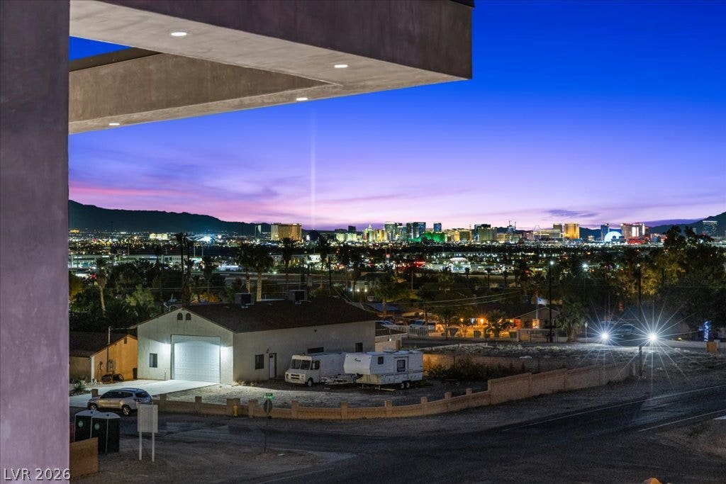2839 Edgemont Drive, Henderson, NV 89074 Capture the breathtaking city lights from this elevated vantage point, showcasing the vibrant skyline at dusk.
