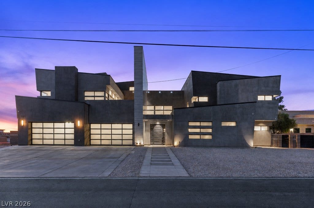 2839 Edgemont Drive, Henderson, NV 89074 Dramatic modern architecture with a striking geometric facade under a vibrant twilight sky.