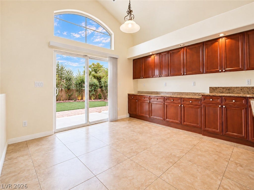 669 Doubleshot Lane, Henderson, NV 89052 Sliding glass doors beneath an arched window welcome natural light onto the tiled floors.