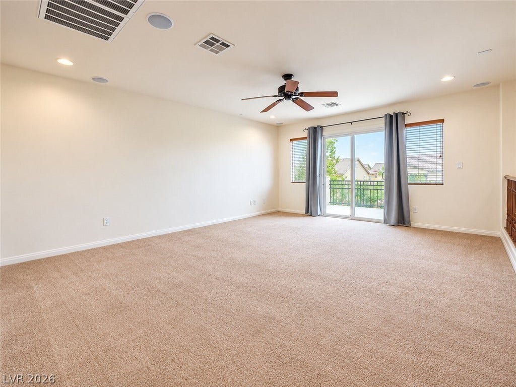 669 Doubleshot Lane, Henderson, NV 89052 Plush carpeting and sliding glass doors defining a versatile upstairs loft space.