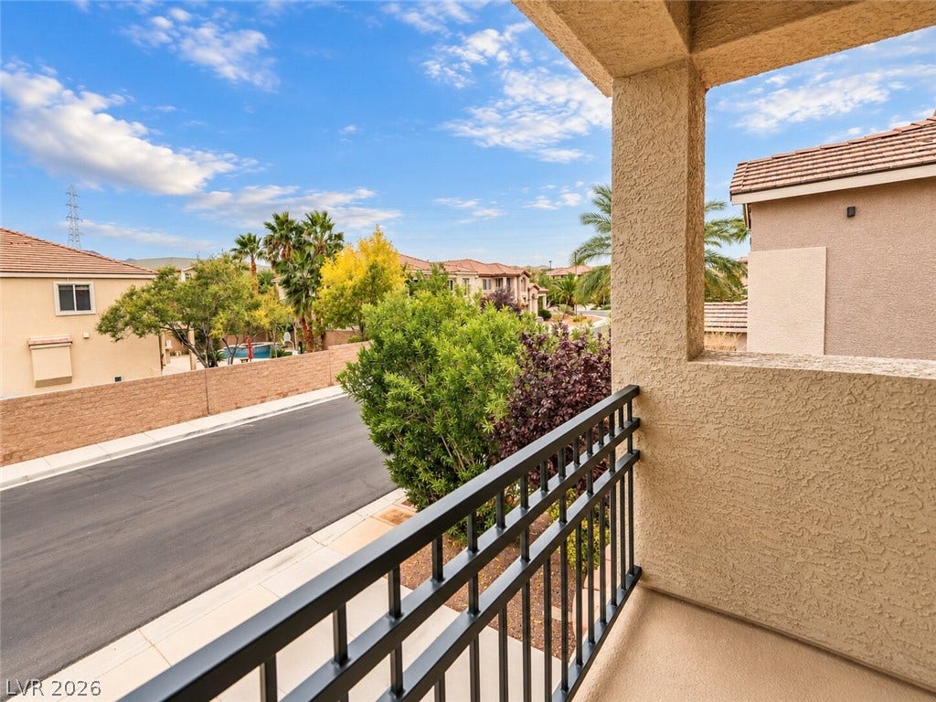 669 Doubleshot Lane, Henderson, NV 89052 A private upper-level balcony overlooks the surrounding neighborhood and scenic tree-lined street below.