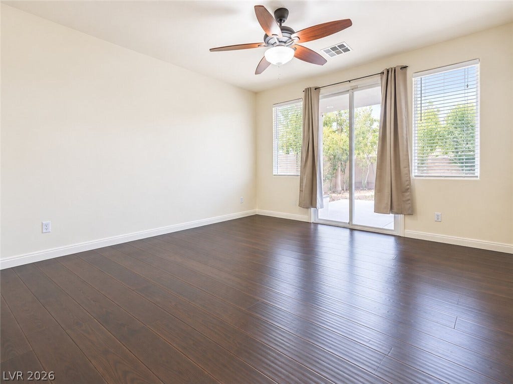 669 Doubleshot Lane, Henderson, NV 89052 Rich wood floors anchor this versatile living space opening directly to the backyard.