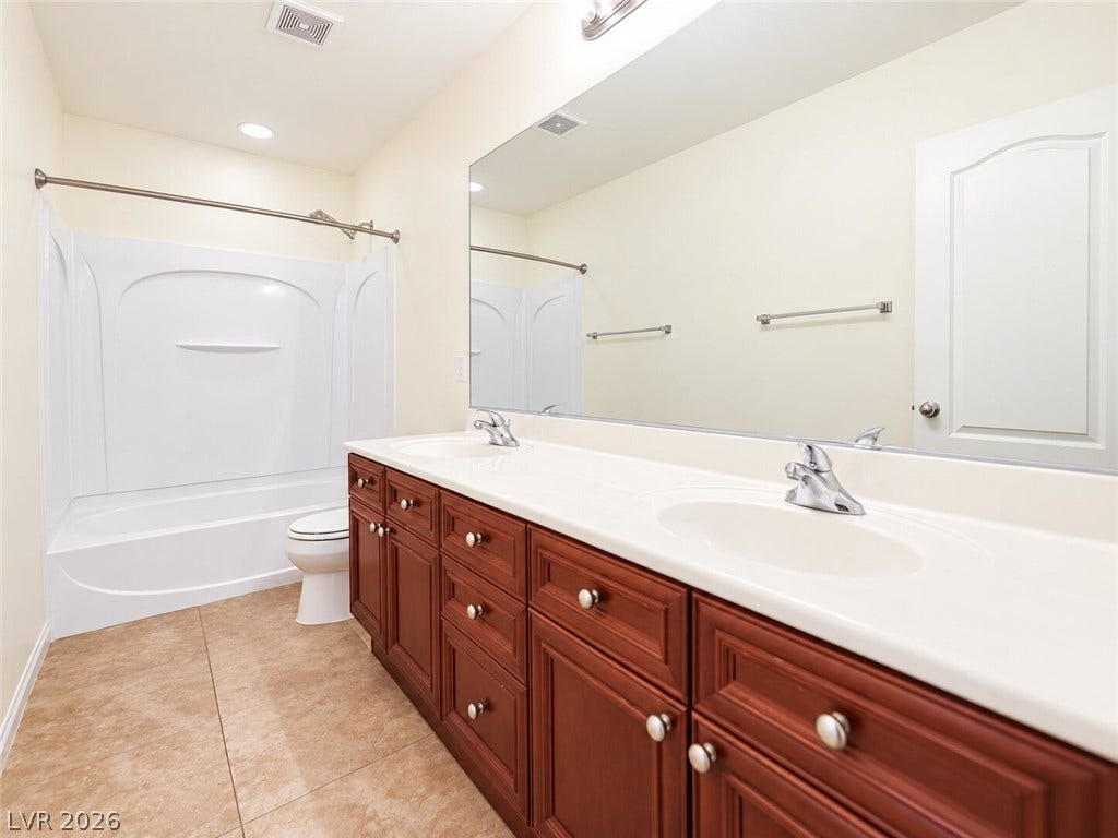 669 Doubleshot Lane, Henderson, NV 89052 A spacious double vanity and tile flooring highlight this classic bathroom configuration.