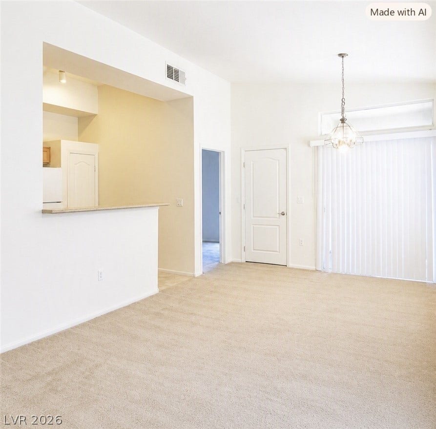 2305 W Horizon Ridge Parkway, #4024, Henderson, NV 89052 An open floor plan connects the carpeted living area to the kitchen pass-through.