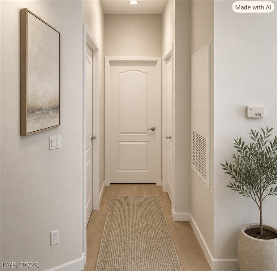 2305 W Horizon Ridge Parkway, #4024, Henderson, NV 89052 Smooth wood flooring and classic panel doors line a cleanly styled interior hallway.