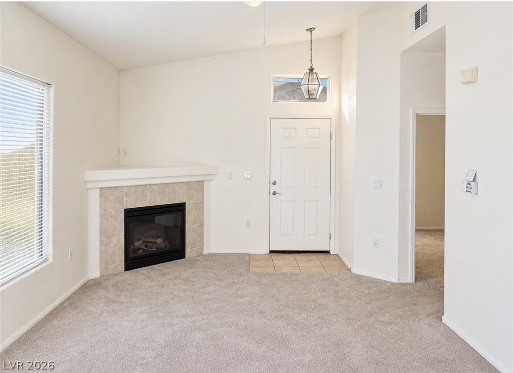 2305 W Horizon Ridge Parkway, #4024, Henderson, NV 89052 An inviting corner fireplace anchors the vaulted living room finished with neutral carpeting.