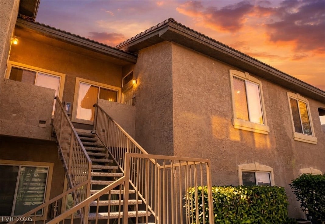 2305 W Horizon Ridge Parkway, #4024, Henderson, NV 89052 Stucco exteriors and tiled rooflines stand out under a colorful sunset sky.