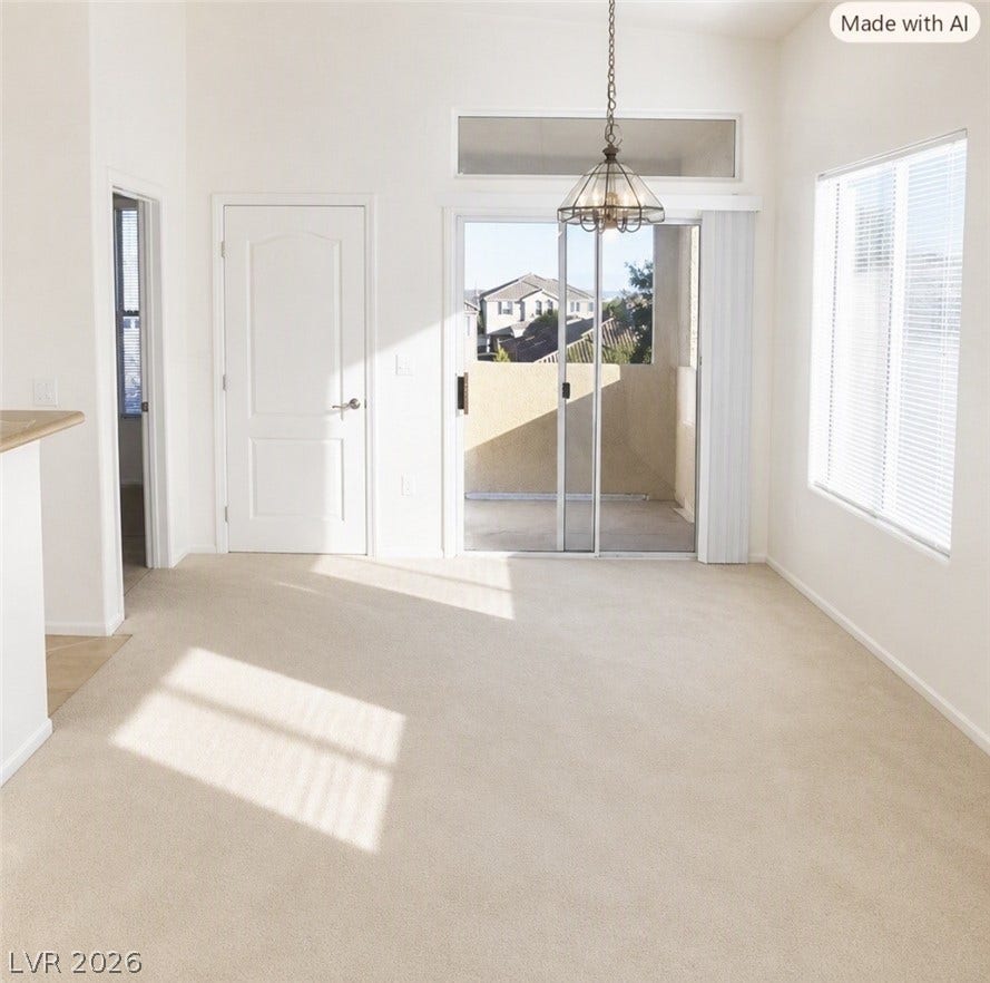2305 W Horizon Ridge Parkway, #4024, Henderson, NV 89052 Natural light pours across the carpeted floors through wide sliding glass doors leading outside.