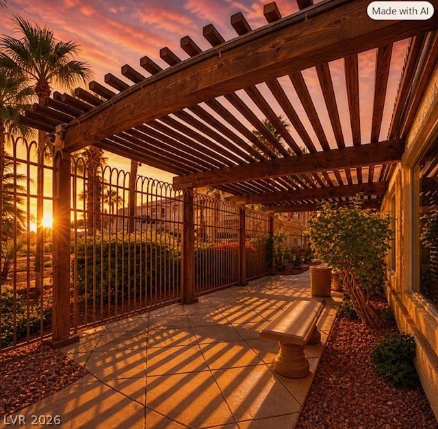 2305 W Horizon Ridge Parkway, #4024, Henderson, NV 89052 A spacious stone patio rests beneath a rustic wooden pergola next to an elegant metal fence.