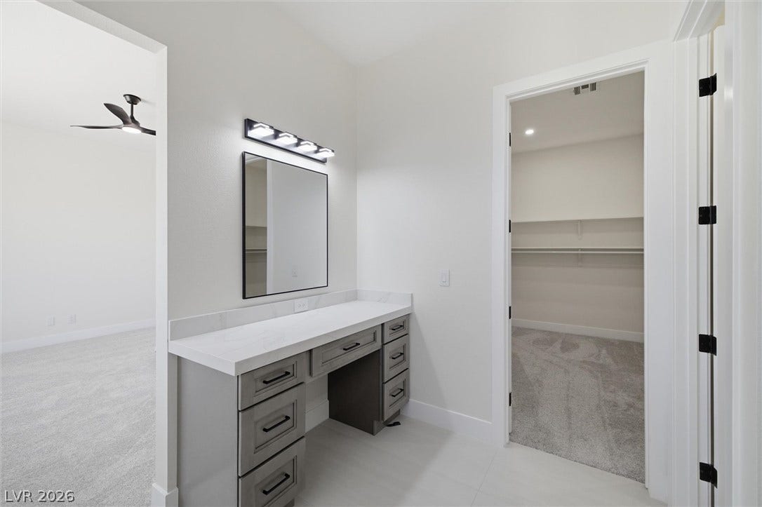 5910 E Kellogg Road, Pahrump, NV 89061 A built-in vanity station transitions smoothly into an adjacent closet and carpeted bedroom.