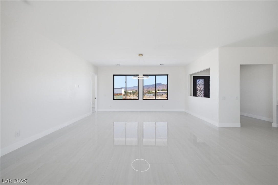 5910 E Kellogg Road, Pahrump, NV 89061 Gleaming polished tile floors reflect natural light beneath soaring ceilings in an airy open room.
