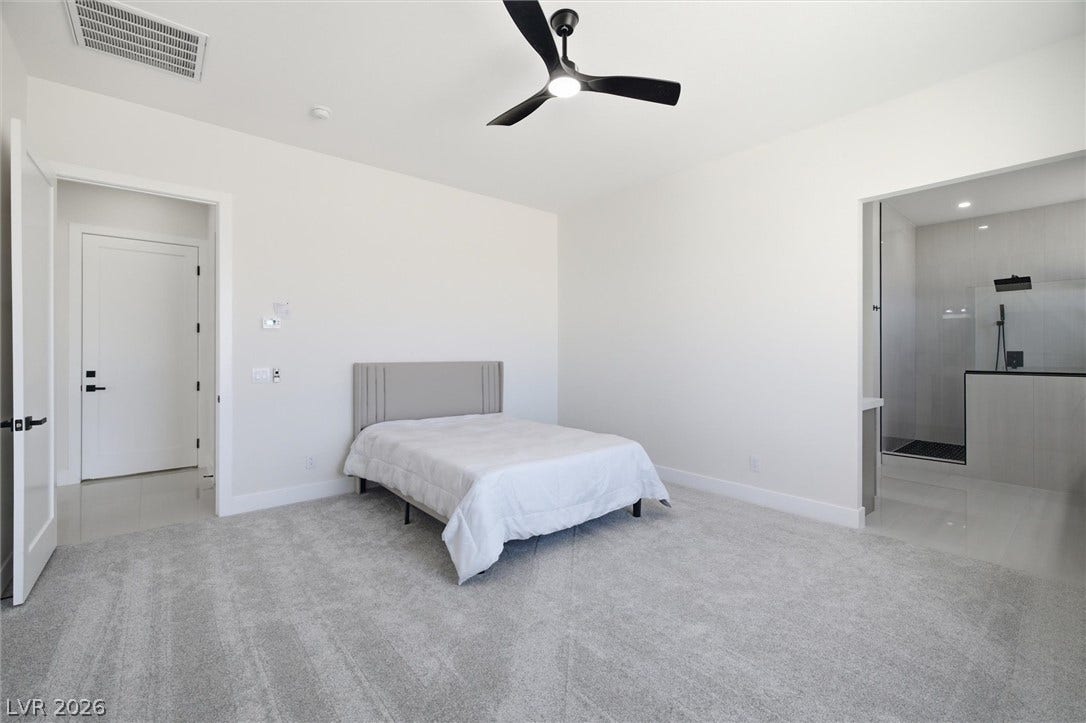 5910 E Kellogg Road, Pahrump, NV 89061 Plush carpeting and an attached bathroom create a private, comfortable suite.