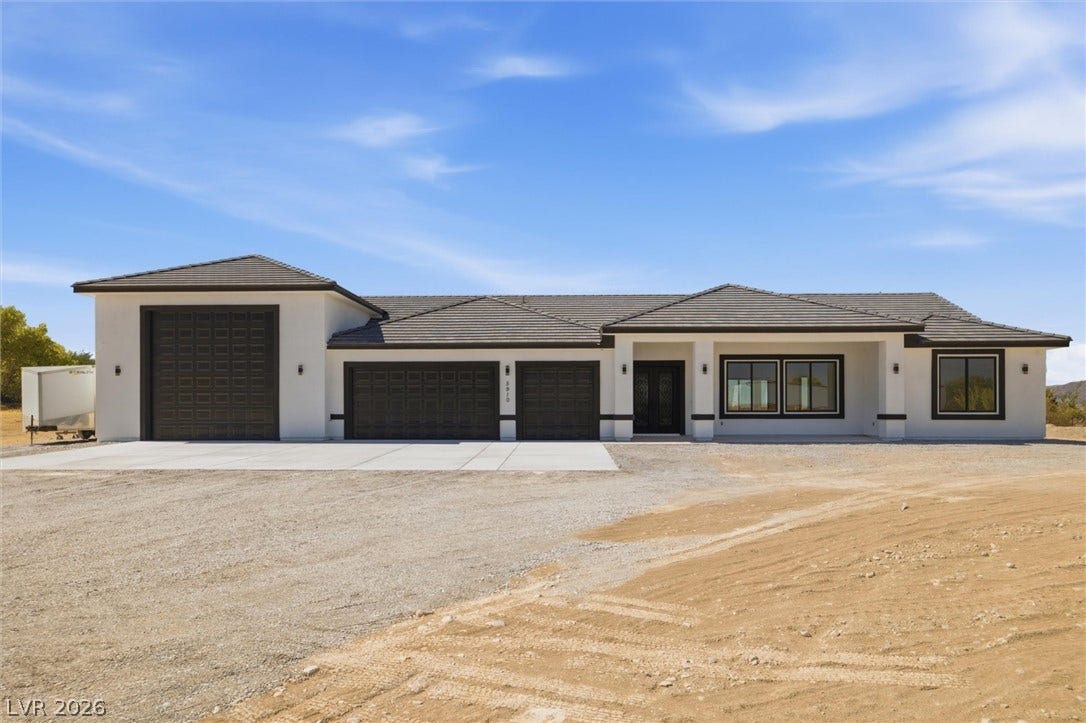 5910 E Kellogg Road, Pahrump, NV 89061 Modern single-level design with an expansive garage configuration highlights this newly constructed exterior.