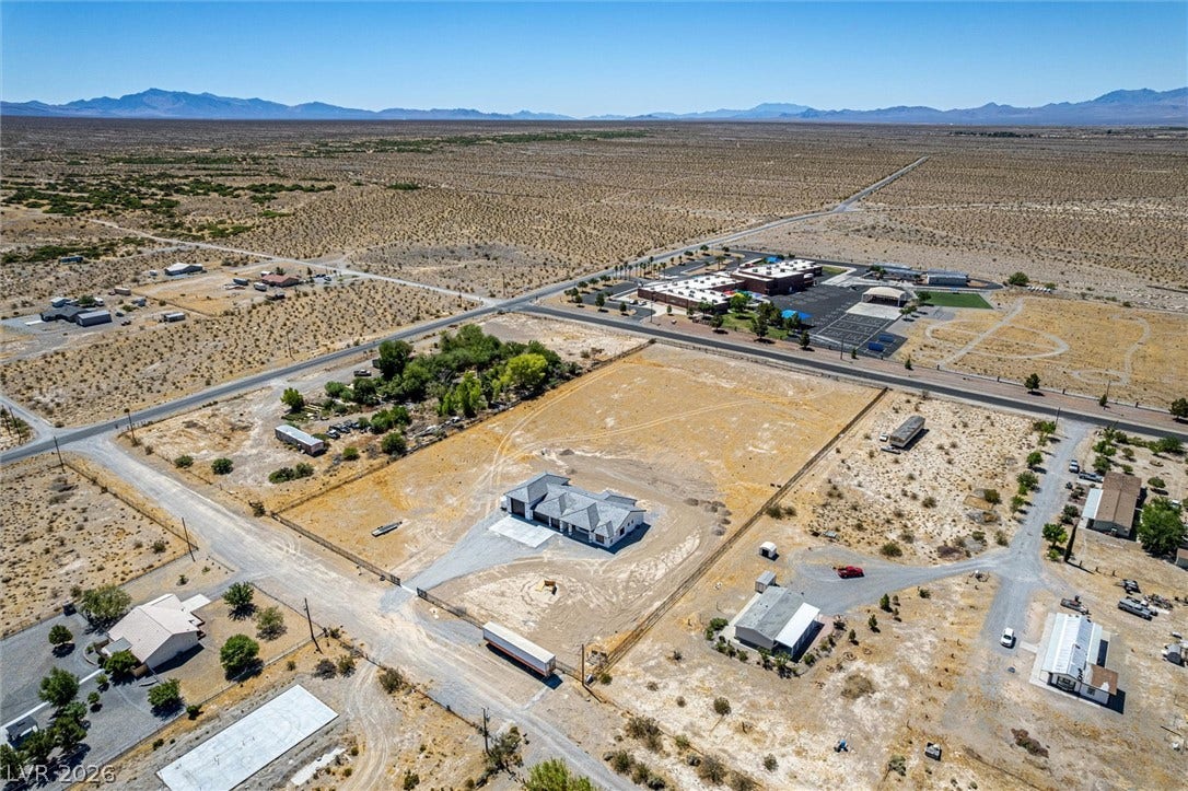 5910 E Kellogg Road, Pahrump, NV 89061 Panoramic mountain and desert vistas surround this expansive property under clear blue skies.
