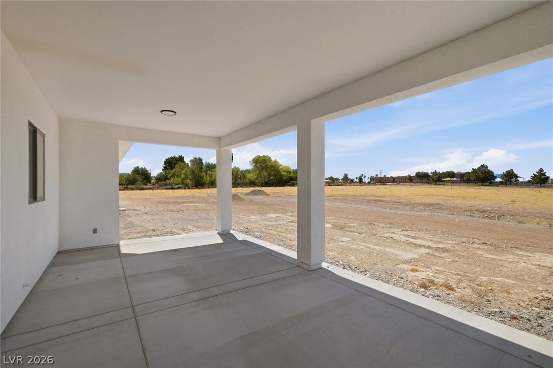 5910 E Kellogg Road, Pahrump, NV 89061 An expansive covered concrete patio looks out onto a wide open surrounding landscape.