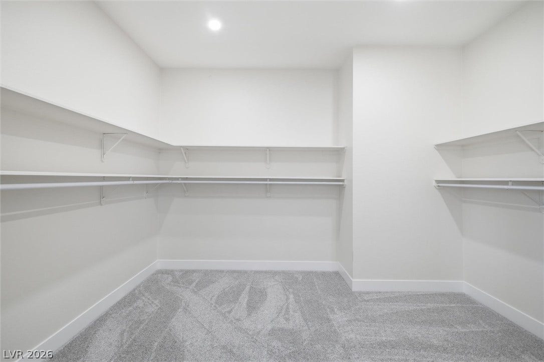 5910 E Kellogg Road, Pahrump, NV 89061 Ample built-in shelving and soft carpeting define this spacious walk-in closet.