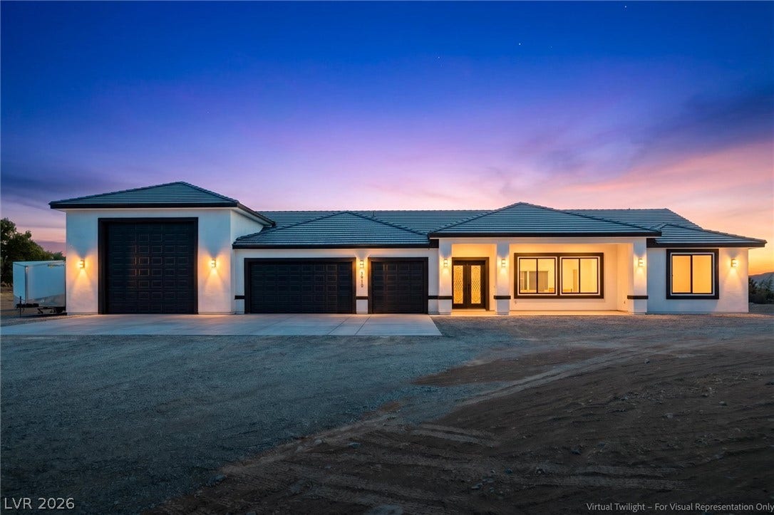 5910 E Kellogg Road, Pahrump, NV 89061 A modern facade glow under dramatic twilight skies highlights clean exterior lines.