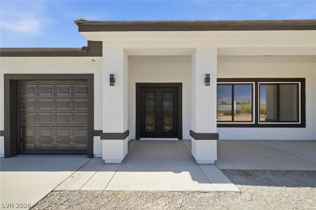 5910 E Kellogg Road, Pahrump, NV 89061 Stately columns flank a concrete entry under a wide overhang.