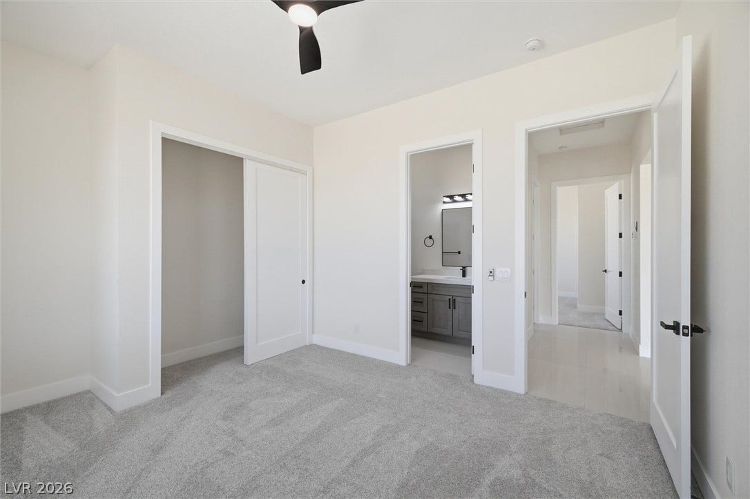 5910 E Kellogg Road, Pahrump, NV 89061 Soft carpeting underfoot anchors this quiet space featuring access to an attached bathroom.