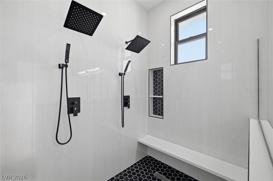 5910 E Kellogg Road, Pahrump, NV 89061 Dual shower heads and a built-in bench highlight this modern tiled shower oasis.
