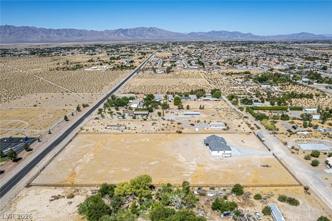 5910 E Kellogg Road, Pahrump, NV 89061 Massive desert acreage surrounds this modern homestead against a backdrop of majestic mountain ranges.